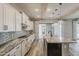Spacious kitchen features an island, sleek countertops, and stainless steel appliances at 18624 W Cathedral Rock Dr, Goodyear, AZ 85338