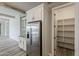 Kitchen with stainless steel refrigerator and a convenient walk-in pantry at 18624 W Cathedral Rock Dr, Goodyear, AZ 85338
