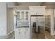 Bright kitchen with stainless steel refrigerator and convenient pantry with shelving at 18624 W Cathedral Rock Dr, Goodyear, AZ 85338