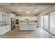 Bright, spacious kitchen features stainless steel appliances, white cabinetry, large island and sliding doors at 18624 W Cathedral Rock Dr, Goodyear, AZ 85338