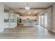 Bright, spacious kitchen features stainless steel appliances, white cabinetry, large island and sliding doors at 18624 W Cathedral Rock Dr, Goodyear, AZ 85338