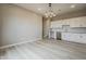 Kitchenette area with white cabinets, stainless steel appliances, white backsplash, and hard surface flooring at 18624 W Cathedral Rock Dr, Goodyear, AZ 85338