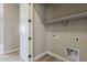 Functional laundry room features overhead shelving and in-wall connections at 18624 W Cathedral Rock Dr, Goodyear, AZ 85338