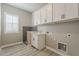 Laundry room featuring cabinets, a sink, and a dog wash station at 18624 W Cathedral Rock Dr, Goodyear, AZ 85338