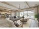 Bright open-concept living room featuring wood beams, modern furniture, and an inviting fireplace at 18624 W Cathedral Rock Dr, Goodyear, AZ 85338