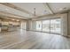 Open-concept living area featuring hardwood floors, wooden beams and a kitchen view at 18624 W Cathedral Rock Dr, Goodyear, AZ 85338
