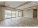 Open-concept living room with sliding glass doors leading to the outdoor patio with charming fireplace at 18624 W Cathedral Rock Dr, Goodyear, AZ 85338