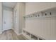 Well lit mud room features a storage bench and built-in coat hooks at 18624 W Cathedral Rock Dr, Goodyear, AZ 85338