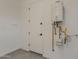 Utility room with a water heater and a door at 18624 W Cathedral Rock Dr, Goodyear, AZ 85338