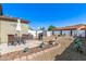Spacious backyard featuring a patio dining set, barbeque grill, shed, firepit, and swing set, all on a gravel base at 1950 E Dust Devil Dr, San Tan Valley, AZ 85143