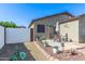 Well-maintained backyard with a dining area, barbecue, and brick-lined planting bed at 1950 E Dust Devil Dr, San Tan Valley, AZ 85143