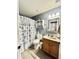Cozy bathroom features a vanity, toilet, and a shower with a patterned curtain at 1950 E Dust Devil Dr, San Tan Valley, AZ 85143