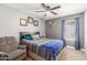 Inviting bedroom with a ceiling fan, window with natural light, and a comfortable armchair at 1950 E Dust Devil Dr, San Tan Valley, AZ 85143