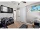 Bedroom includes a closet, TV, a nearby ensuite bathroom and an office area at 1950 E Dust Devil Dr, San Tan Valley, AZ 85143