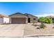 Charming single-story home with a two-car garage and desert landscaping at 1950 E Dust Devil Dr, San Tan Valley, AZ 85143