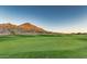 Lush green golf course with scenic mountain views and natural desert landscaping at 1950 E Dust Devil Dr, San Tan Valley, AZ 85143