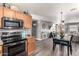 Modern kitchen features stainless steel appliances and an open floor plan to the dining area at 1950 E Dust Devil Dr, San Tan Valley, AZ 85143