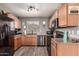 Efficient kitchen featuring stainless steel appliances, wood cabinets, and ample counter space at 1950 E Dust Devil Dr, San Tan Valley, AZ 85143