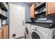 Laundry room with side-by-side washer and dryer, overhead shelving, and direct access to the exterior at 1950 E Dust Devil Dr, San Tan Valley, AZ 85143