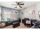 A functional home office space complete with a comfortable couch, desk, and modern equipment at 1950 E Dust Devil Dr, San Tan Valley, AZ 85143