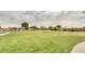 Large green space with walking path, perfect for outdoor activities and relaxing in the community at 1950 E Dust Devil Dr, San Tan Valley, AZ 85143