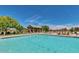 Resort-style pool with lounge chairs and covered seating area offers community recreation at 1950 E Dust Devil Dr, San Tan Valley, AZ 85143