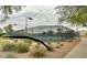 Community tennis courts with black chain-link fencing surrounded by desert landscaping at 1950 E Dust Devil Dr, San Tan Valley, AZ 85143