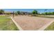 Bright sand volleyball court surrounded by mature trees and beautiful grassy area at the community park at 1950 E Dust Devil Dr, San Tan Valley, AZ 85143