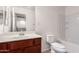 Bathroom with sink, toilet and shower and cherry colored cabinets at 1950 N Center St # 115, Mesa, AZ 85201