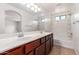 Bright bathroom featuring double sinks, granite counters, and a shower-tub combo at 1950 N Center St # 115, Mesa, AZ 85201