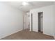 Bedroom featuring carpet, closet, ceiling fan, and an open door at 1950 N Center St # 115, Mesa, AZ 85201