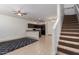 Open-concept living area with tile flooring, modern kitchen, and staircase to upper level at 1950 N Center St # 115, Mesa, AZ 85201