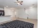 Bright, open living area with tile flooring, leading to the modern kitchen and staircase at 1950 N Center St # 115, Mesa, AZ 85201
