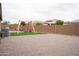 Expansive backyard with gravel, artificial grass, swing set, and block wall fence at 19814 W Buchanan St, Buckeye, AZ 85326
