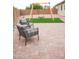 Charming backyard featuring brick patio, seating, and a swing set on artificial grass at 19814 W Buchanan St, Buckeye, AZ 85326