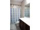 Bathroom with blue shower curtain and dark wood vanity at 19814 W Buchanan St, Buckeye, AZ 85326
