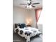 Brightly lit bedroom with ceiling fan, grey carpet, and a window at 19814 W Buchanan St, Buckeye, AZ 85326