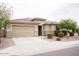Beautiful single-story home showcasing a well-kept front yard and a spacious two-car garage at 19814 W Buchanan St, Buckeye, AZ 85326