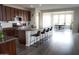 Open kitchen with a large island, granite countertops, dark wood cabinets, and a view to the dining area at 19814 W Buchanan St, Buckeye, AZ 85326