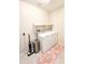 Well-lit laundry room with washer, dryer, shelf, and a rug at 19814 W Buchanan St, Buckeye, AZ 85326