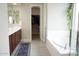 Bright main bathroom with double vanity, soaking tub and walk-in closet access at 19814 W Buchanan St, Buckeye, AZ 85326