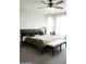 Well-lit main bedroom featuring a ceiling fan, plush bedding and a bench at 19814 W Buchanan St, Buckeye, AZ 85326