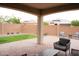 Covered patio with brick, lawn, landscape borders, and seating area at 19814 W Buchanan St, Buckeye, AZ 85326