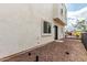 View of a gated backyard with rock landscaping, exterior building, and some trees at 2000 N 36Th St # 29, Phoenix, AZ 85008