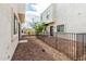 View of a gated backyard with rock landscaping and exterior of building at 2000 N 36Th St # 29, Phoenix, AZ 85008