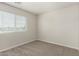 Cozy bedroom with plush carpeting and a window bringing in natural light at 2000 N 36Th St # 29, Phoenix, AZ 85008