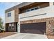 Modern two-story home with a stone facade, private balcony, and desert landscaping at 2000 N 36Th St # 29, Phoenix, AZ 85008