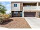 Stylish two-story home featuring a stone facade and private balcony, with desert landscaping at 2000 N 36Th St # 29, Phoenix, AZ 85008