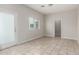 Bright, open room with neutral tile flooring, a large window, and access to other areas at 2000 N 36Th St # 29, Phoenix, AZ 85008