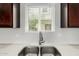 Modern kitchen sink with stainless steel fixtures and bright lighting at 2000 N 36Th St # 29, Phoenix, AZ 85008